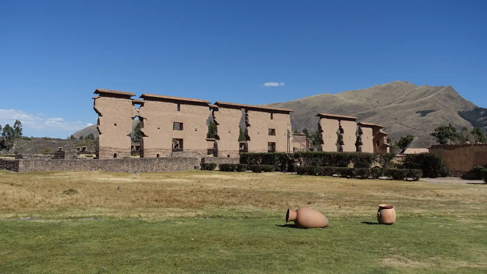 Raqchi, Peru: the central adobe wall of the Temple of Wiracocha under a blue sky